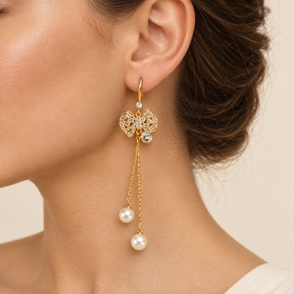 Butterfly crystal and pearl drop earring worn on a beautiful ear